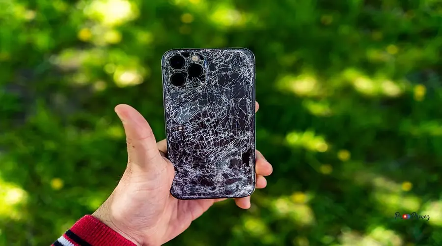 a broken phone screen in a man’s hand a broken phone screen in a man's hand.