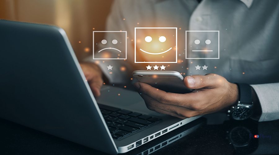 Business man holding phone wiht virtual screen on the happy Smiley face icon to give satisfaction in service. rating very impressed. Customer service and Satisfaction concept