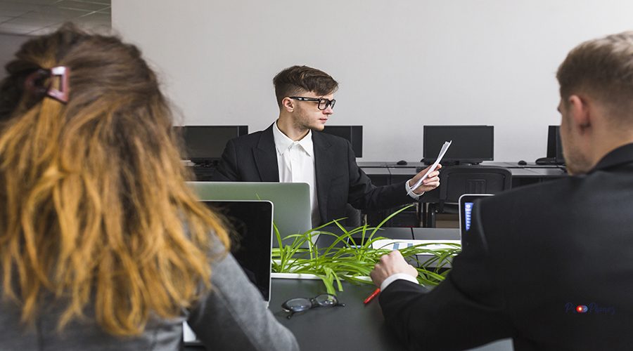 close-up-business-partner-sitting-front-manager-looking-document