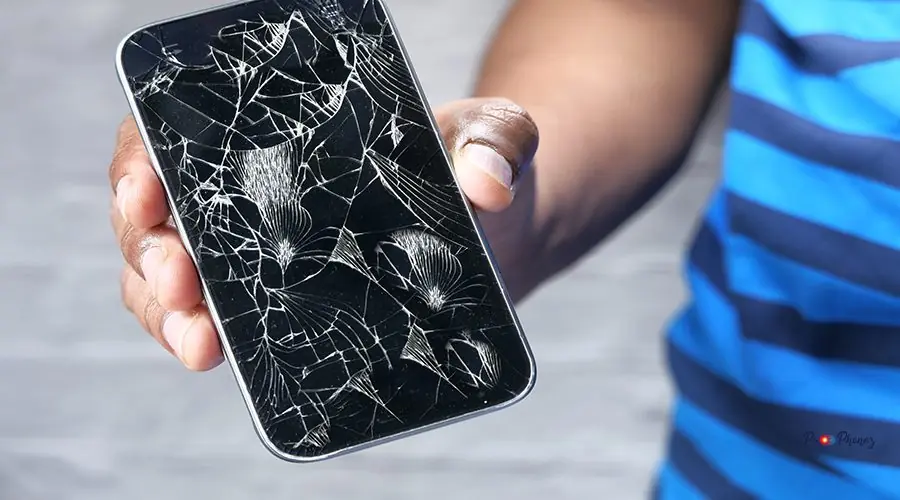 Close up of man hand holding broken smart phone. Close up of man hand holding broken smart phone