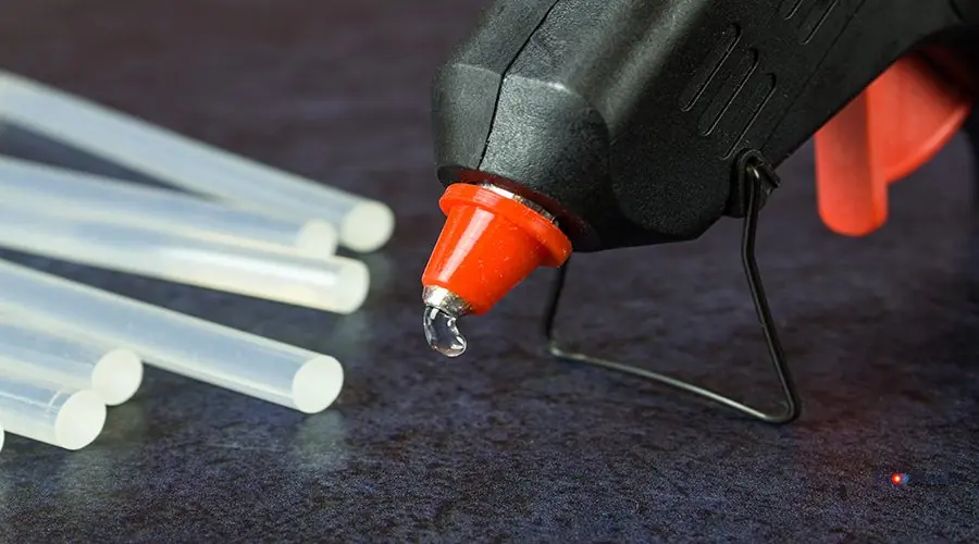 Close-up of a thermo gun with glue sticks Close-up of a thermo gun with glue sticks