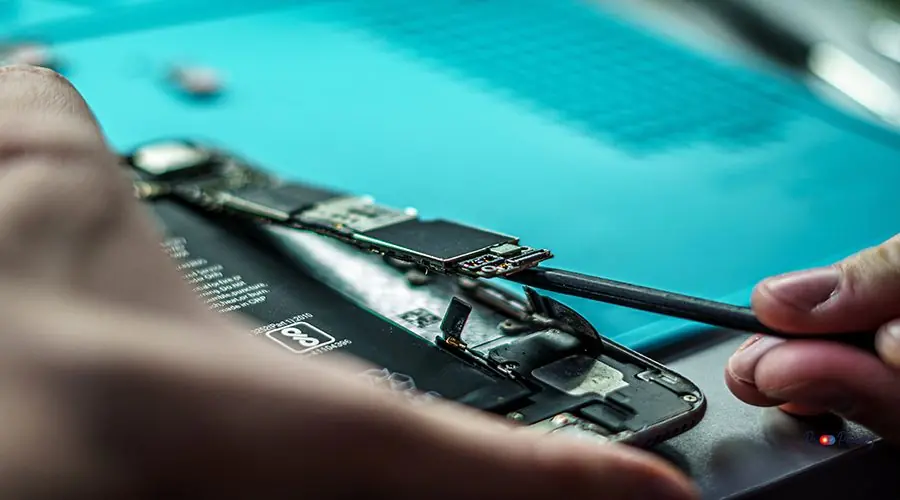 Closeup shot of a person repair a mobile in mobile repair smartphone workshop A closeup shot of a person repair a mobile in mobile repair smartphone workshop