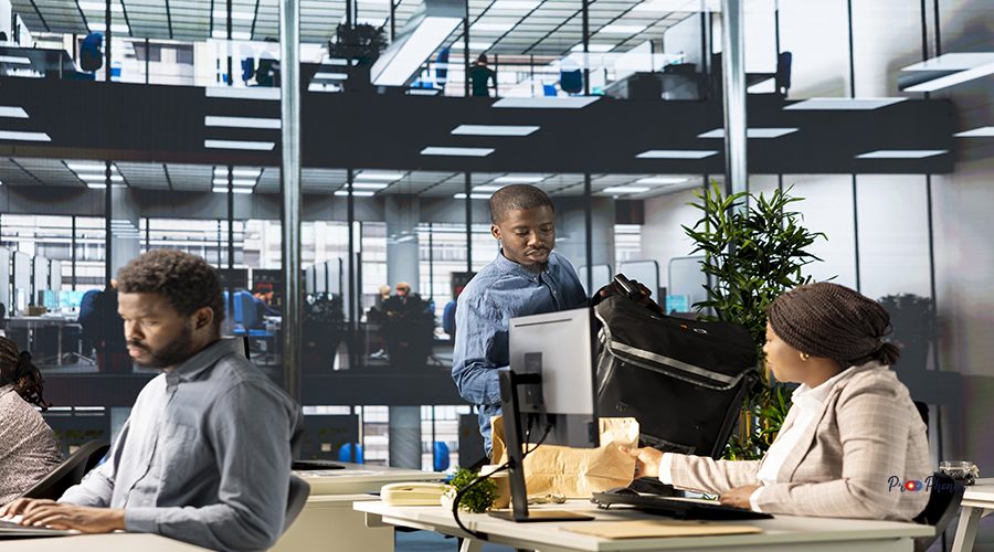 Corporate woman employee receiving a food delivery at her desk. Great takeaway service at the modern workplace, worker interacting with courier, customer service in a professional setting.