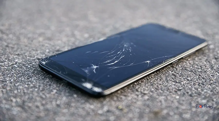Damaged smartphone with broken touch screen on asphalt Damaged smartphone with broken touch screen on the asphalt