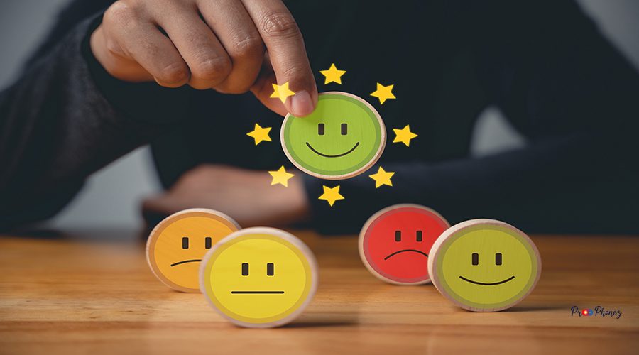 Hand holding a wooden block circle with a smiley face, selecting the best service rating. Customer satisfaction survey concept with 5-star satisfaction and excellent business experience.