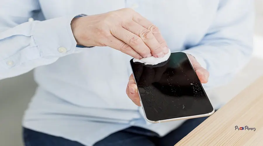 high-angle-elder-woman-disinfecting-her-smartphone high-angle-elder-woman-disinfecting-her-smartphone