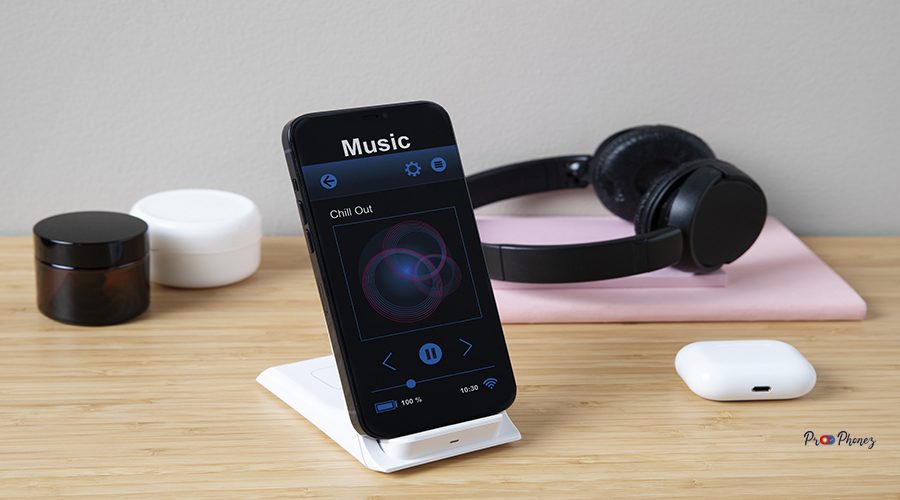 high-angle-smartphone-desk-with-headphones