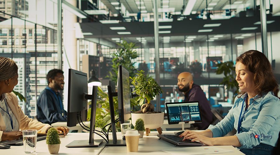 Joyous coworkers having fun in vibrant office while reviewing financial graphs. Cheerful colleagues sharing jokes while working, looking over data trends and strategic insights, camera B