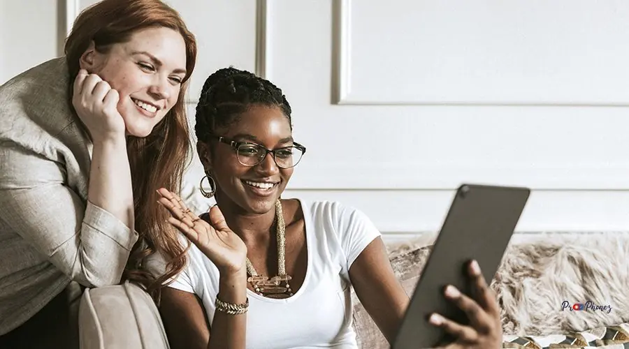 Lesbian couple having a video call with friends Lesbian couple having a video call with friends