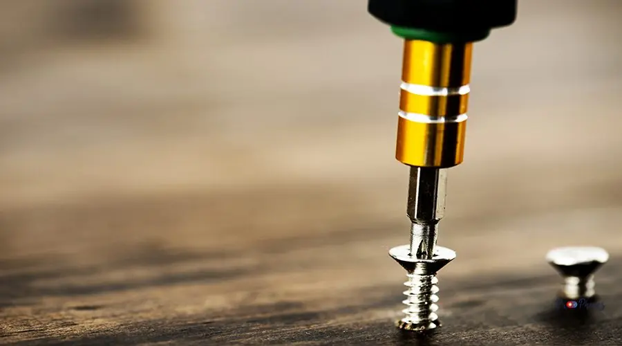 Macro shot of screw on wooden background Macro shot of screw on wooden background