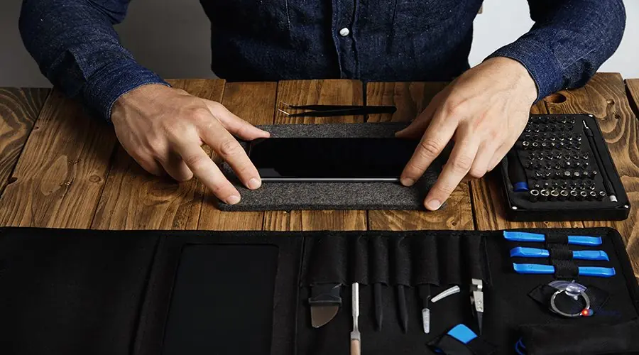 Electronic repair service Man is prepares smartphone for restoration Fixing electronic device service works