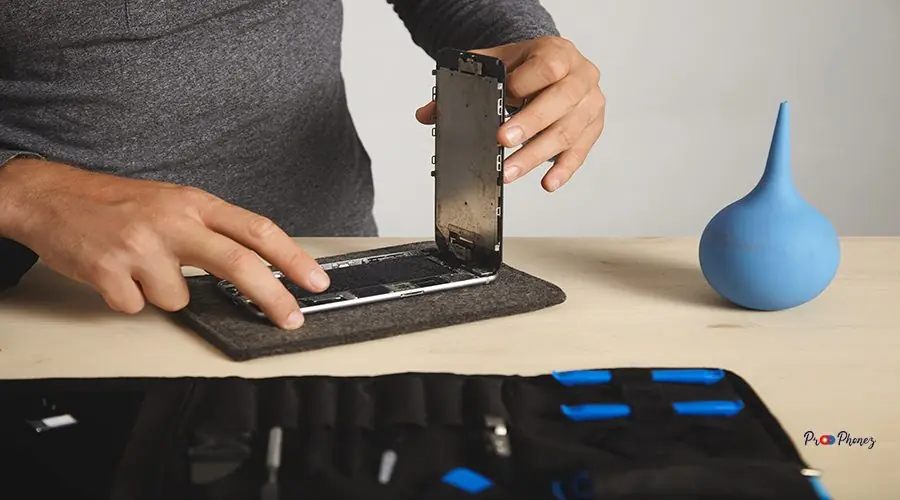 Computer and phone repairment service Man removes broken screen on his smartphone to change it, electronic repairment service