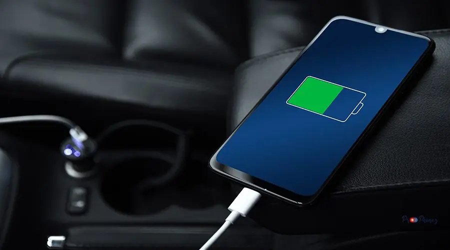 Mobile phone ,smartphone, cellphone is charged ,charge battery with usb charger in the inside of car. modern black car interior Mobile phone ,smartphone, cellphone is charged ,charge battery with usb charger in the inside of car. modern black car interior.