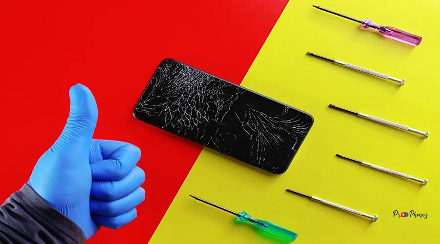 The phone with the broken screen lies on a red and yellow background with screwdrivers The phone with the broken screen lies on a red and yellow background with small screwdrivers and a gloved hand of a master. Phone Repair Shop background with copy space. Top view