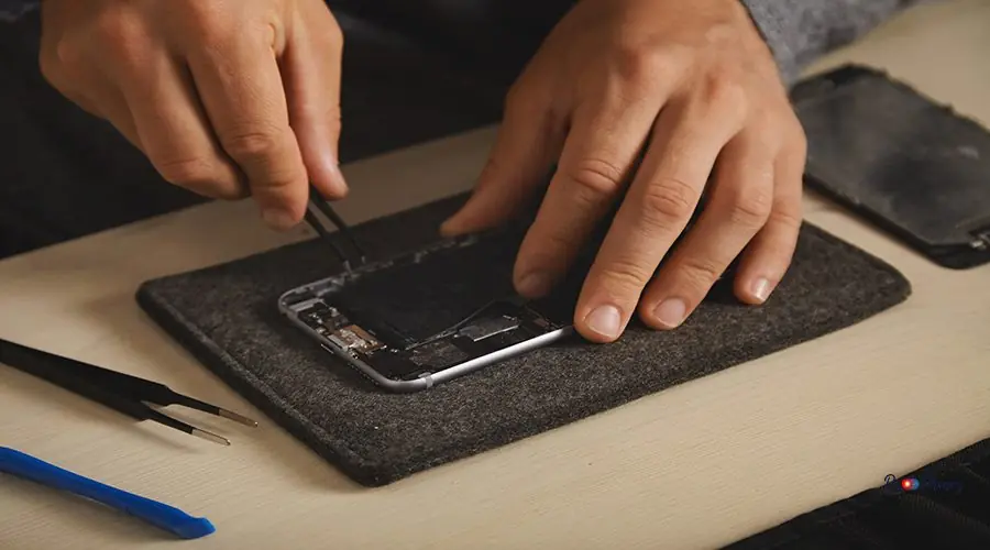 Computer and phone repairment service Removing old bli-on battery from disassembled smartphone to replace it with new one, electronic repairment service