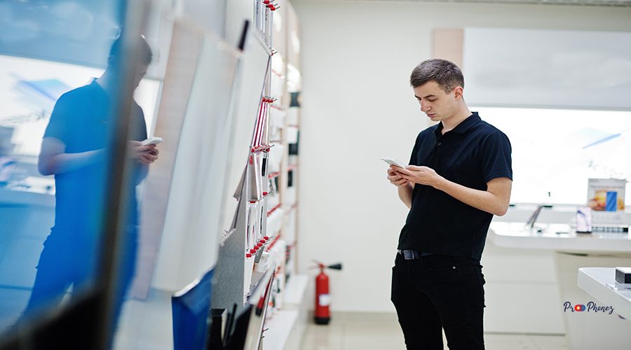 Seller man mobile phone professional consultant in tech store or shop.