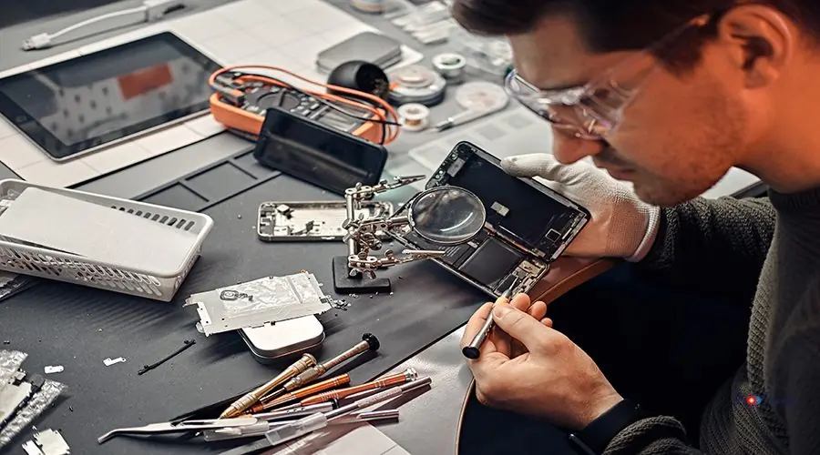 Technician carefully inspect the internal parts of the smartphone in a modern repair shop iphone 13 back glass replacement