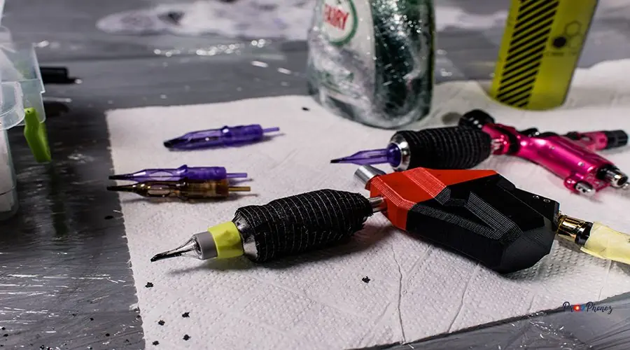 A tattoo artist makes a tattoo in a salon A tattoo artist makes a tattoo in a salon