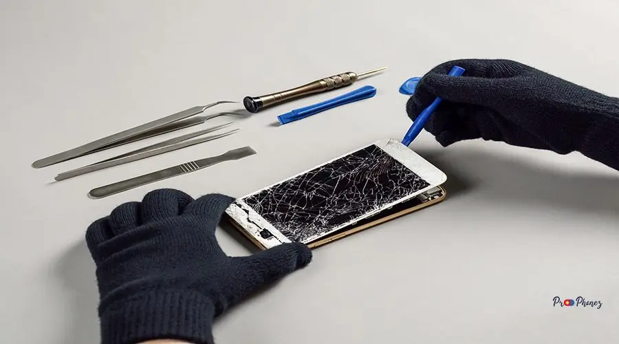 Technician repairing broken smartphone on desk Technician or engineer opening broken smartphone for repair or replace new part on desk