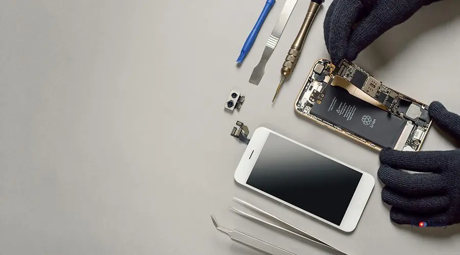 Technician repairing broken smartphone on desk Technician or engineer disassembling components broken smartphone and take off logic board for repair or replace new smartphone logic board on desk