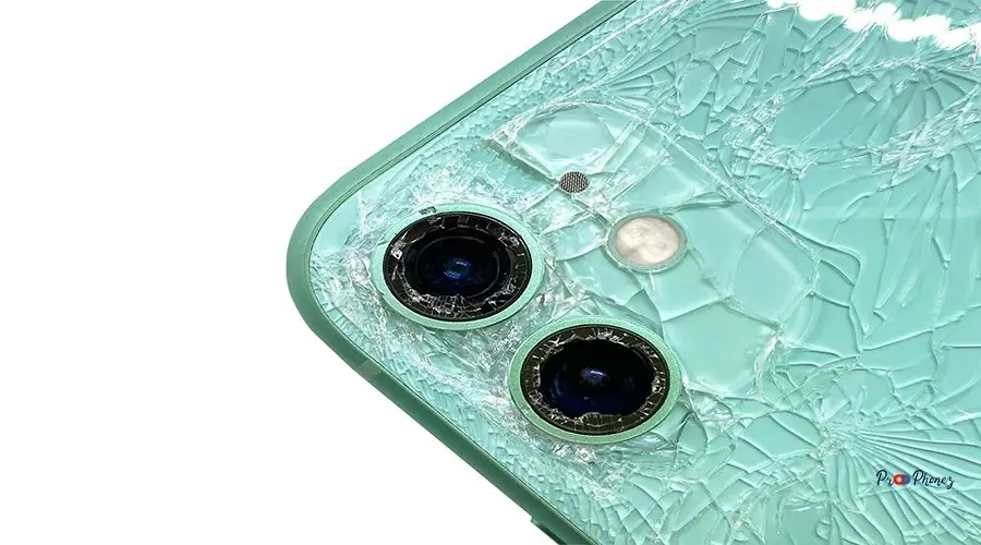 Top view the back of green modern smartphone with a broken glass and a damaged camera close-up isolated on white background Top view the back of green modern smartphone with a broken glass and a damaged camera close-up isolated on white background