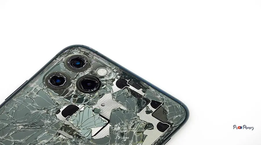 Top view the back of midnight green modern smartphone with a broken glass and a damaged camera close-up isolated on white background Top view the back of midnight green modern smartphone with a broken glass and a damaged camera close-up isolated on white background