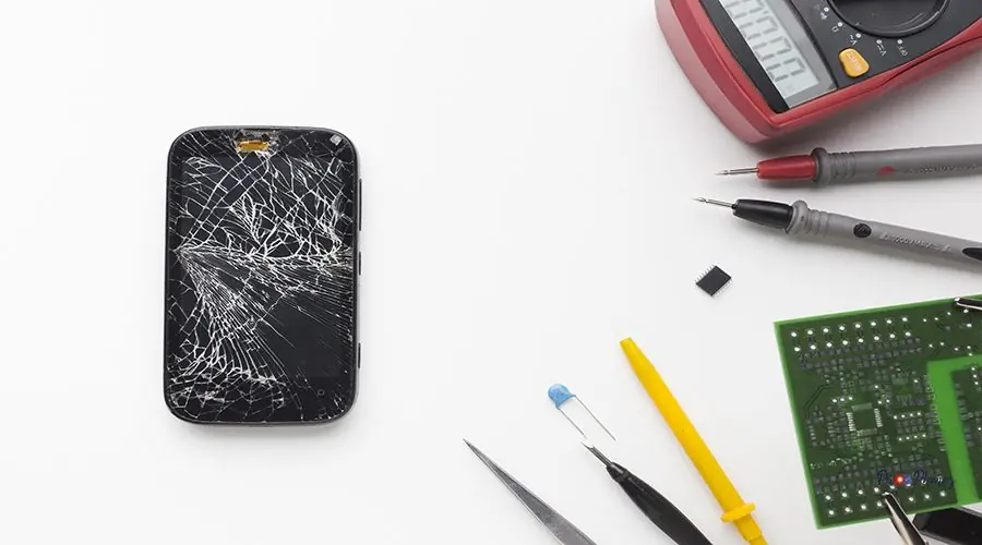 top-view-broken-phone-with-electronic-tools top-view-broken-phone-with-electronic-tools