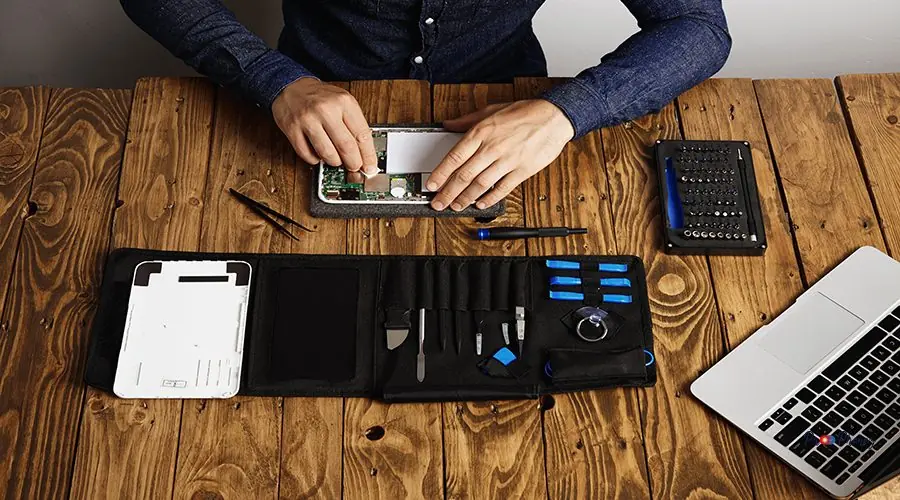 Electronic repair service Top view professional clean electronic device on wooden table in his lab near his tools before disassemble