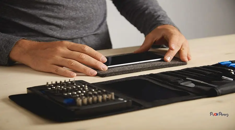 Computer and phone repairment service Unrecognizable technician preparing broken smartphone for dissassembling process
