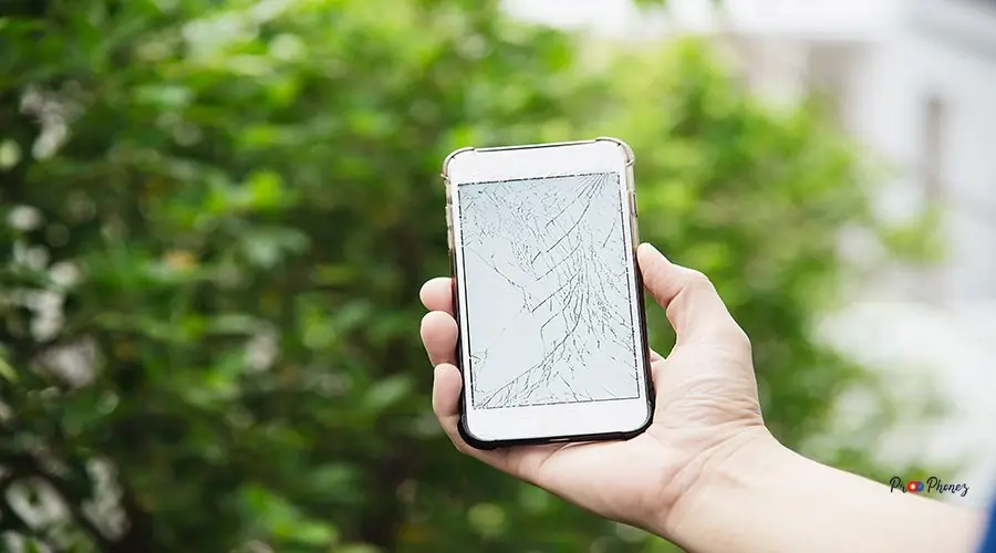 Man holding broken mobile with damaged display Man holding broken mobile with damaged display