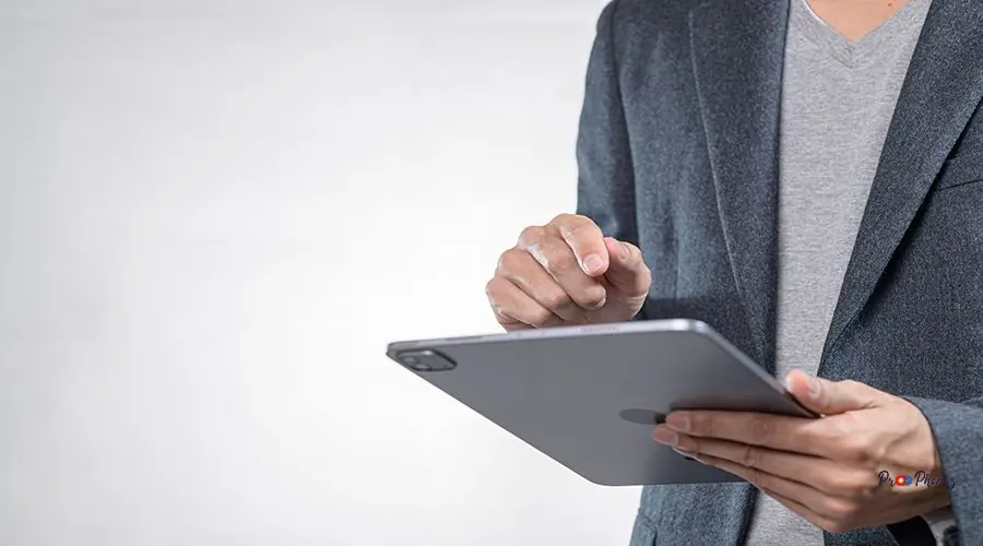 Professional Man Using Tablet Device in Modern Business Setting cracked iphone screen