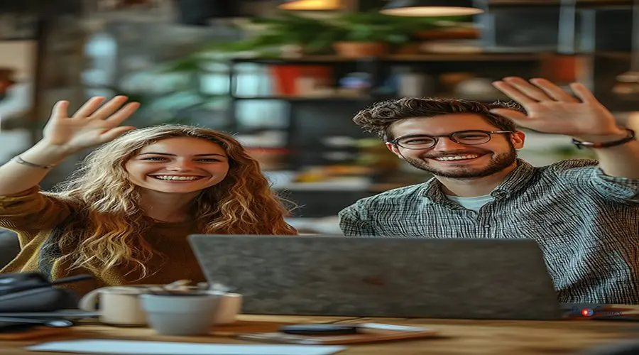 two people high-fiving over laptop, celebrating marketing succes cracked iphone screen