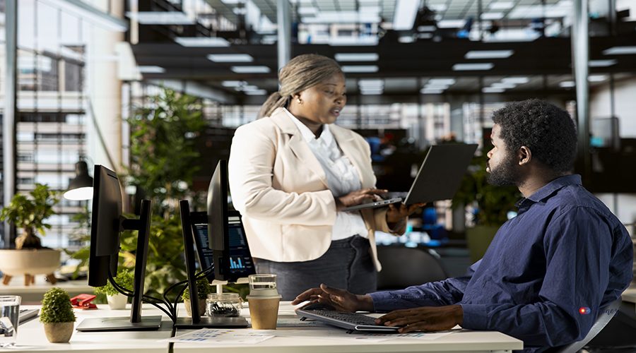 Work team in the office engaged in infographics analysis for problem solving tasks, financial planning to support business growth and accomplish strategic objectives. Multinational company.